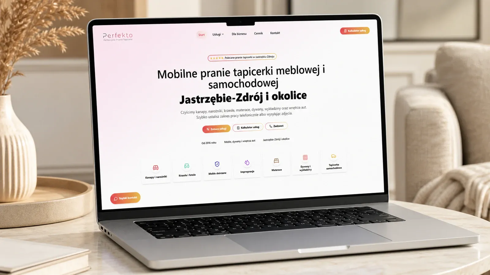 Strona internetowa PERFEKTO pokazana na laptopie w jasnym wnętrzu